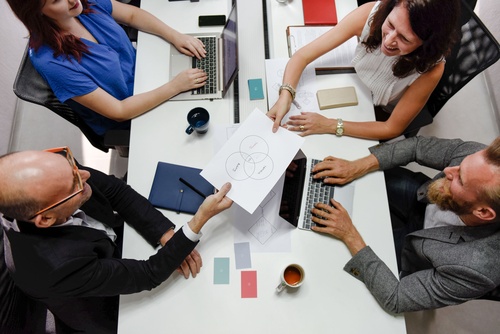 Image of a group of professionals working at their office