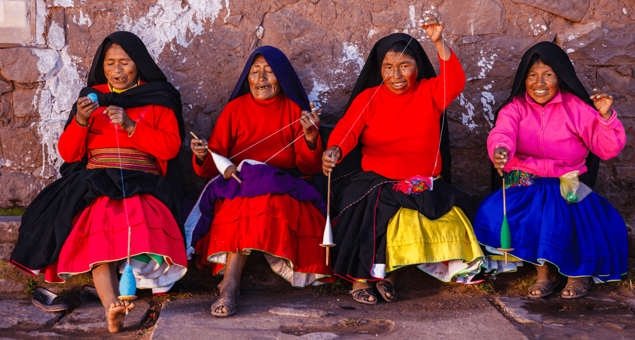 Very happy and cheerful indigenous women from Latin America dressed in typical clothes