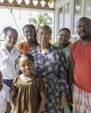 Banner image of a family from Trinidad & Tobago at their house.