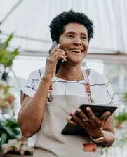 Image of a caribbean woman who runs a plants small business