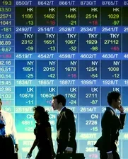 people in front of stock market screen