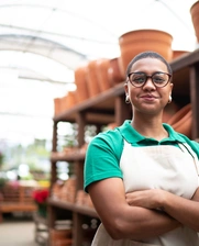 Image of a female Brazilian entrepreneur smiling at her pottery business