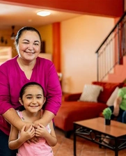 Image of a happy Mexican family at their new house.