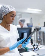 A female technician checking a tablet in a laboratory
