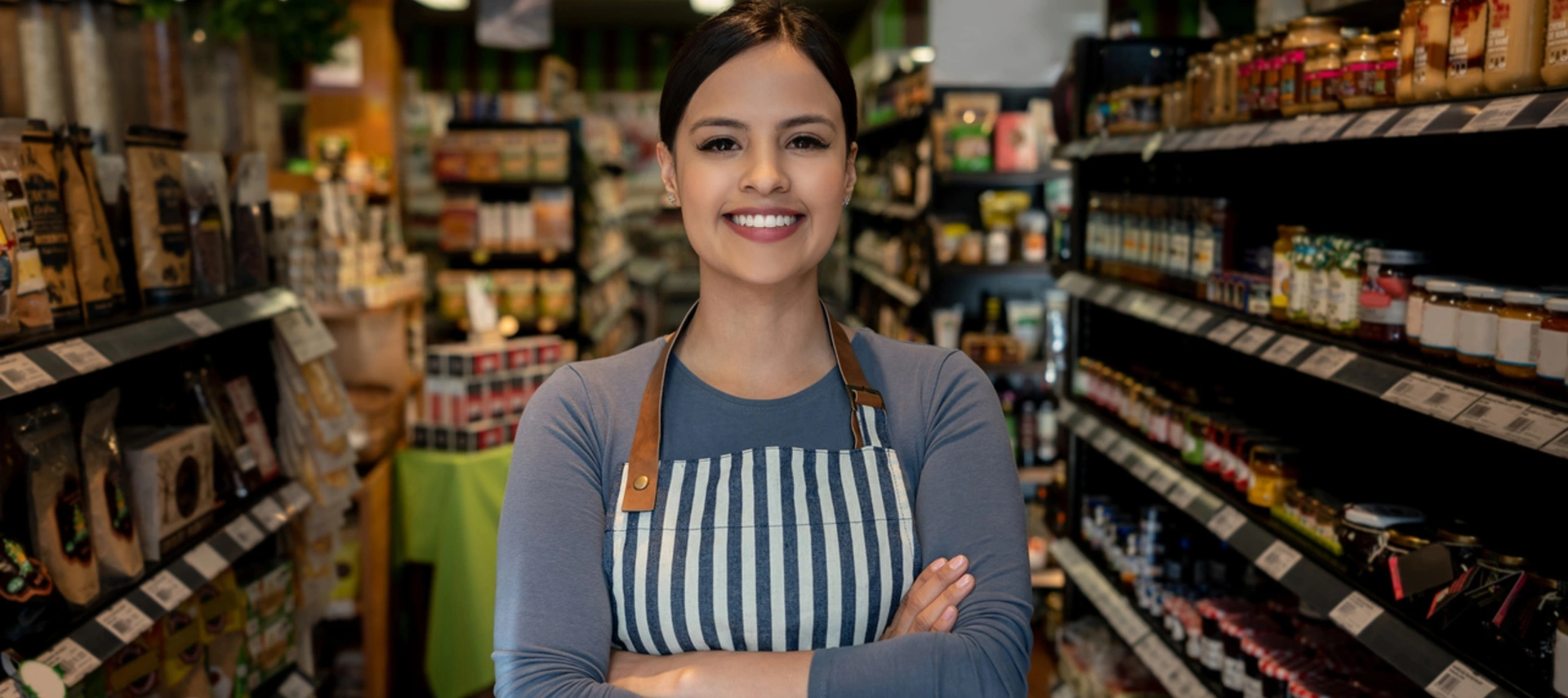 Image of a woman who works at a supermarket smiling