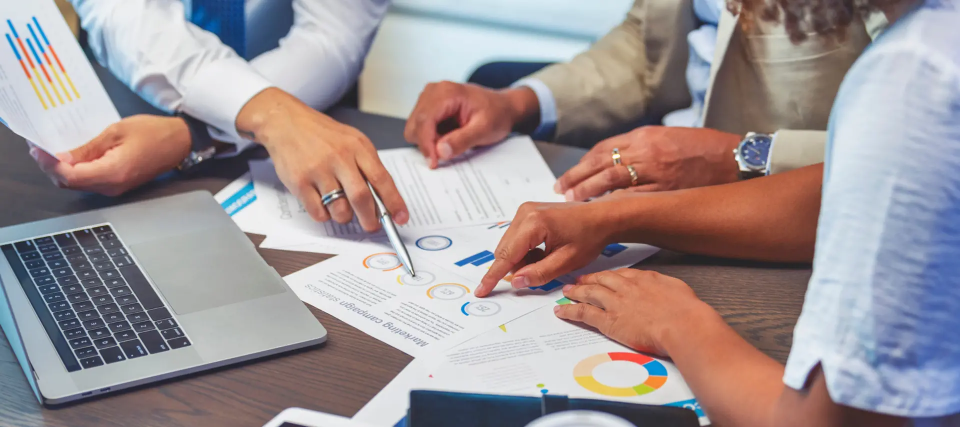 Image showing a group of office workers checking financial documents on a desk