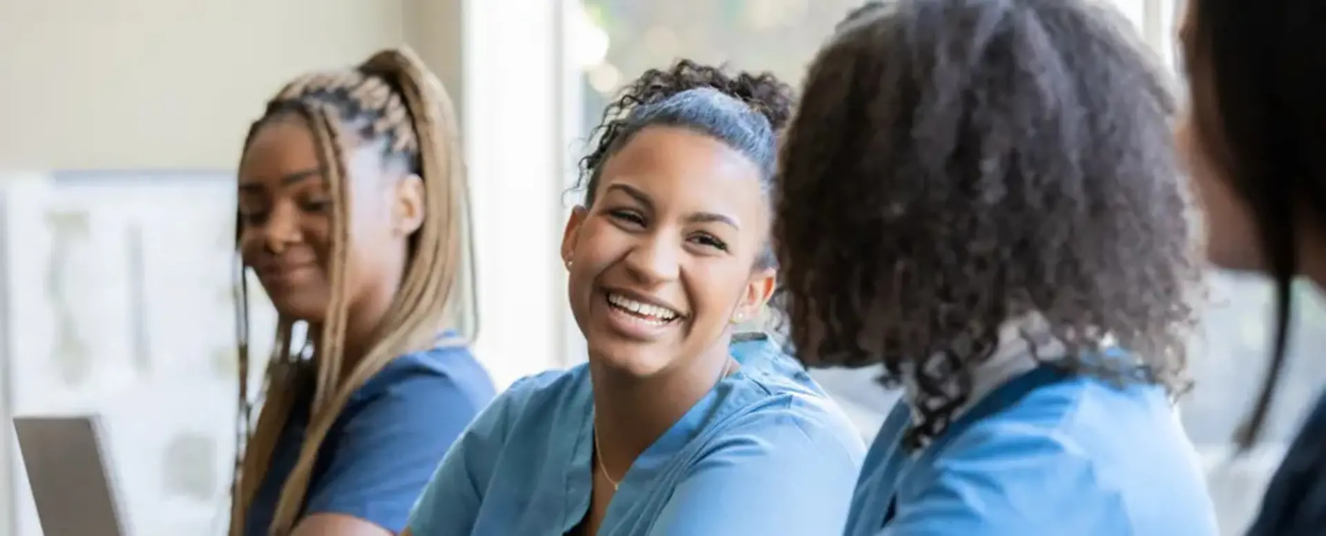 Three health care workers smiling image