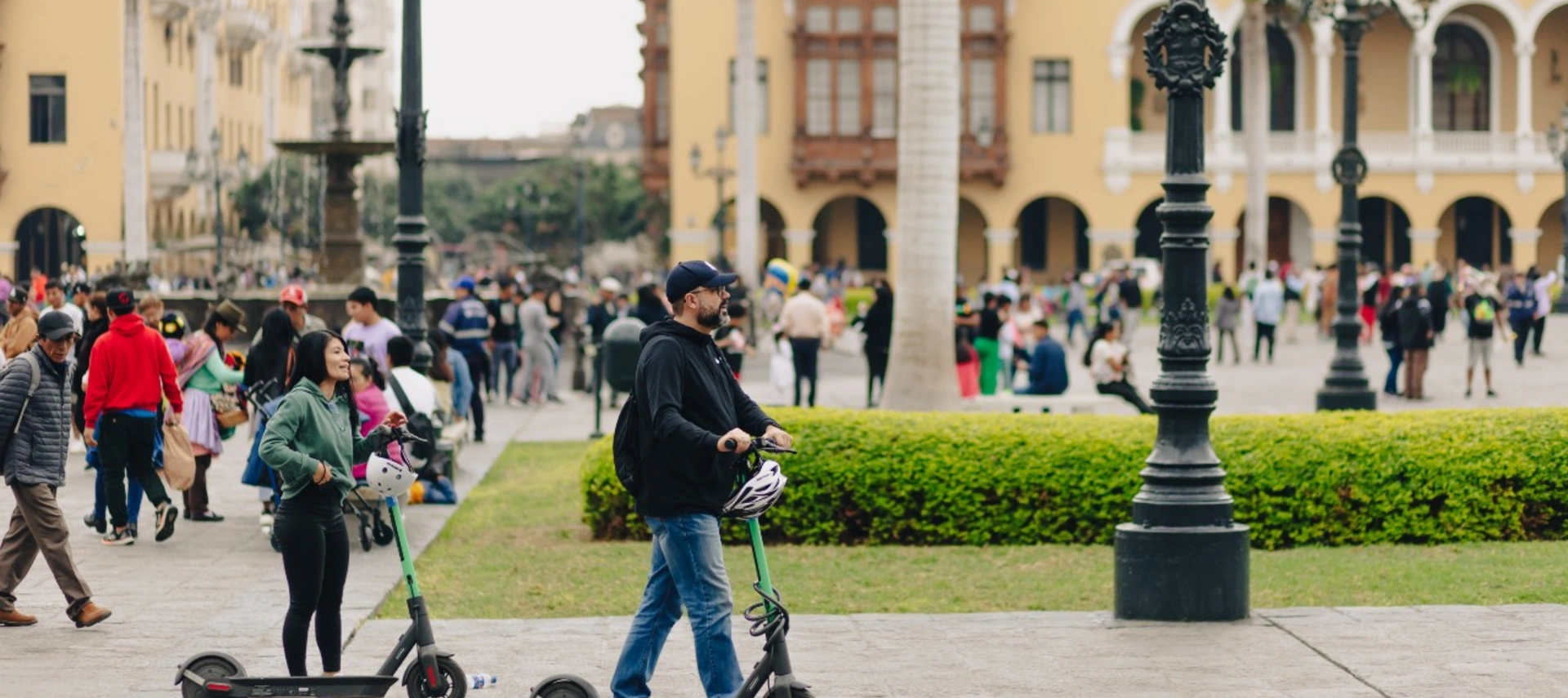 People riding scooters in downtown Lima