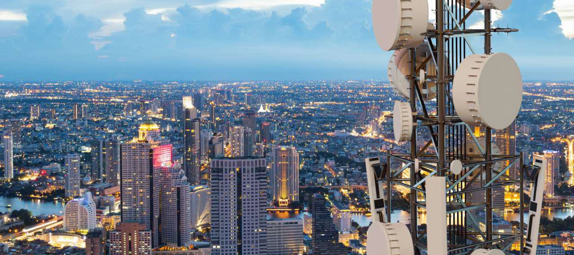 Banner image showing a city panoramic from the top of a building with communication antenas