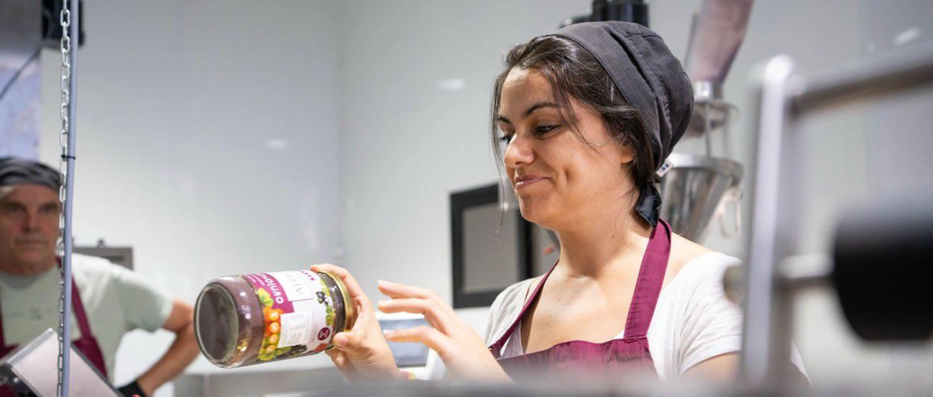 Image of a smiling employee of a jam factory