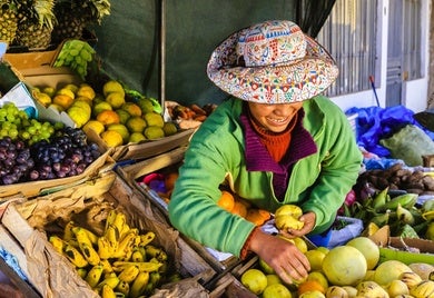 A Peruvian woman at her fruit stand