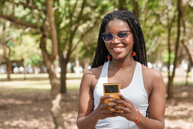 A young woman holding a cellphone 