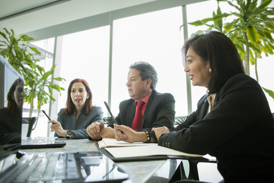 A business meeting of two women and a man