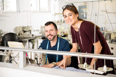 Two young tailors in a factory.