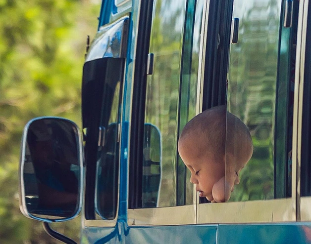 Image of a baby sleeping while traveling in a bus