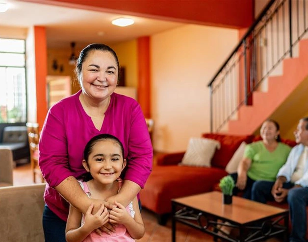 Image of a happy Mexican family at their new house.