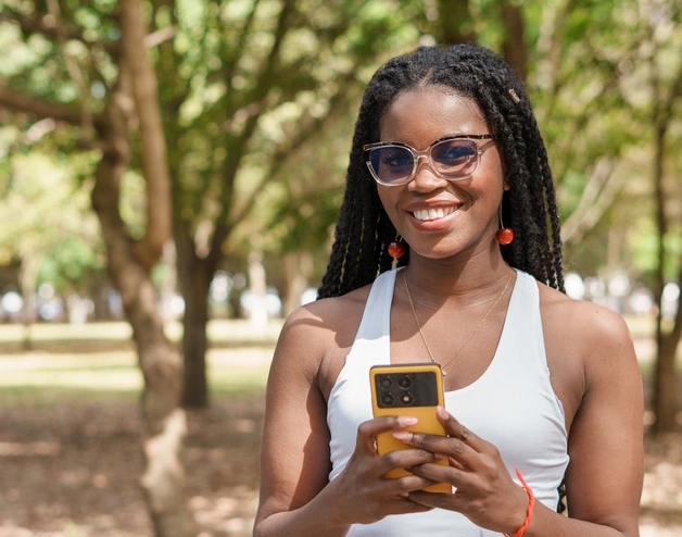 A young woman holding a cellphone 