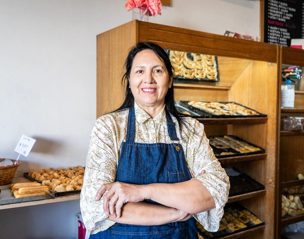 Image of an smiling woman at her bakery