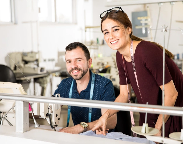 Two young tailors in a factory.