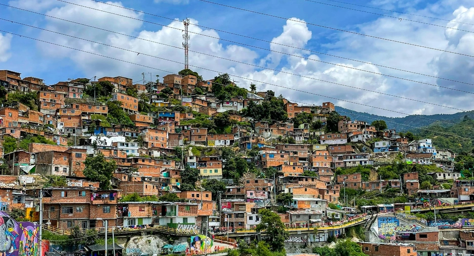 A view of a city with a hill in the background. Daniel Duque on Unsplash. Used under Creative Commons License.