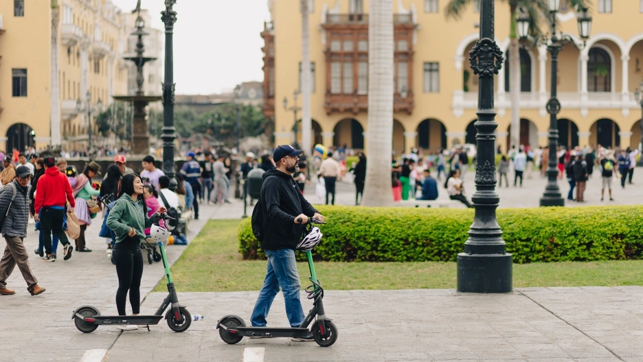 People riding scooters in downtown Lima