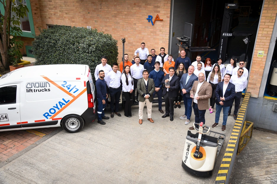 a team of workers standing together next to a van