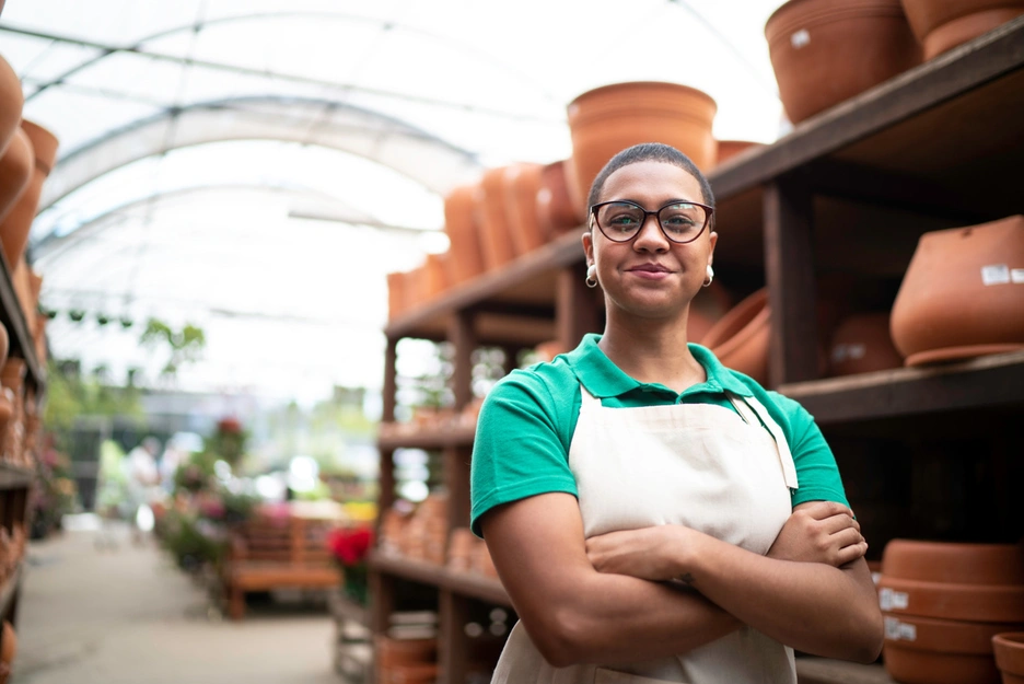 Image of a female Brazilian entrepreneur smiling at her pottery business