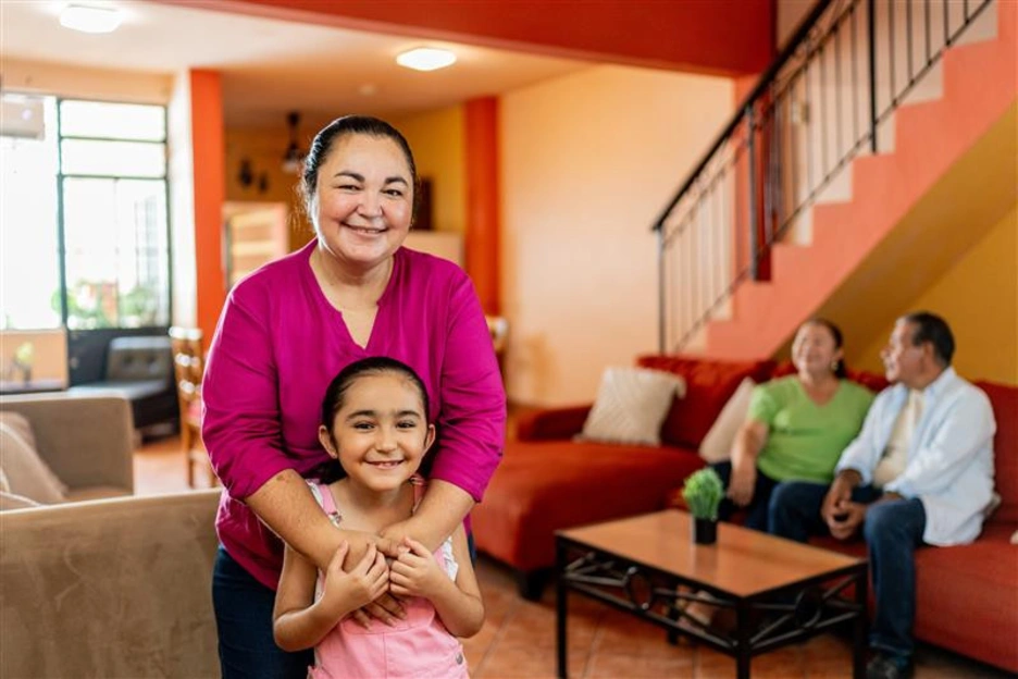 Image of a happy Mexican family at their new house.