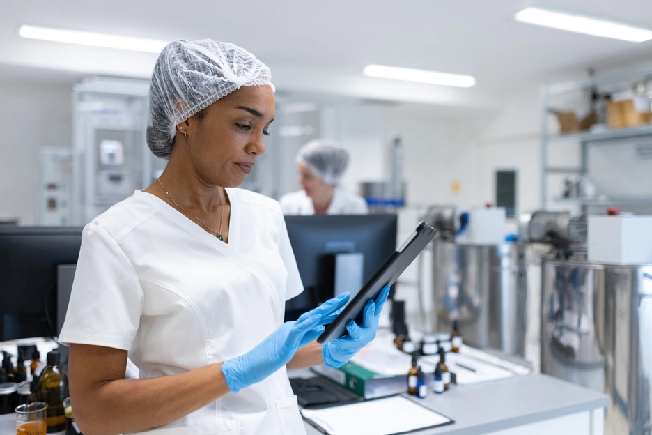 A female technician checking a tablet in a laboratory