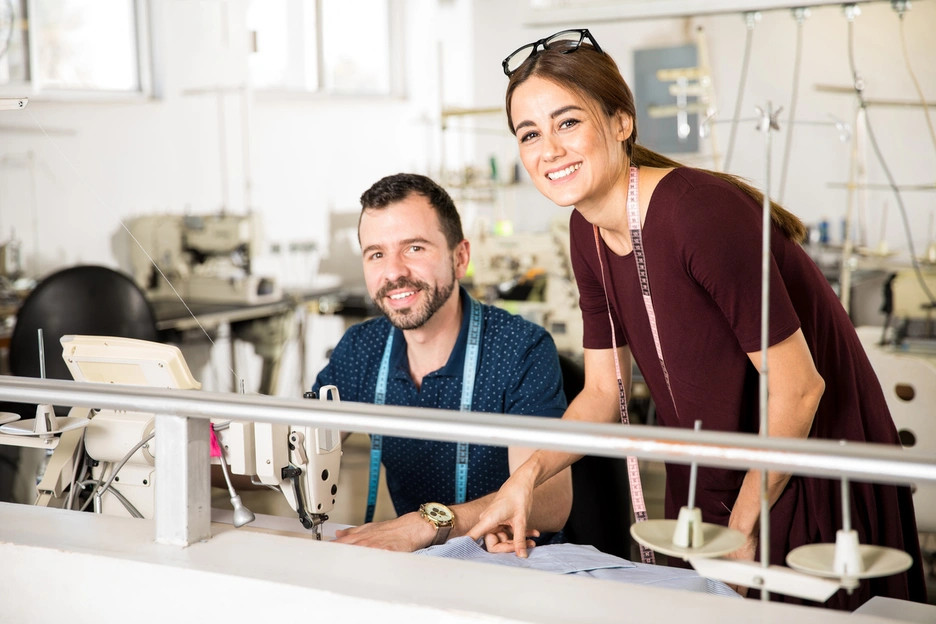 Two young tailors in a factory.