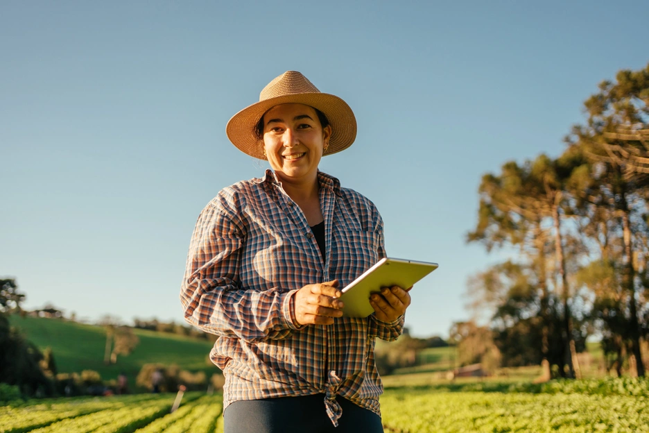 Woman holding a tablet in a rural area